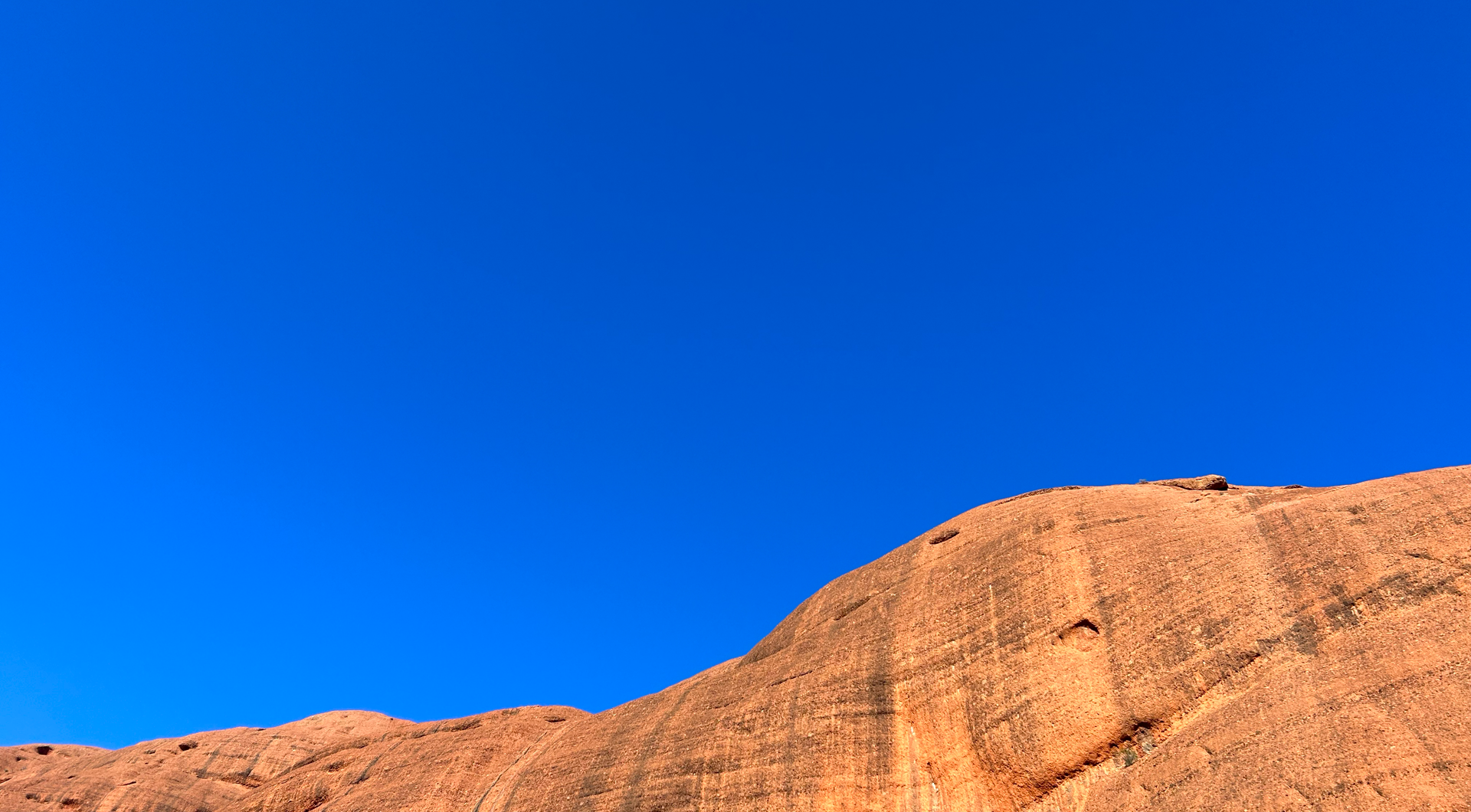 The red rocks of Kata Tjuta against a clear blue sky along the Valley of the Winds walk in the Red Centre.